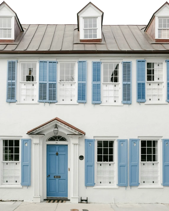 blue shutters are on the side of this building