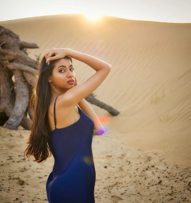 a woman standing in front of a large desert