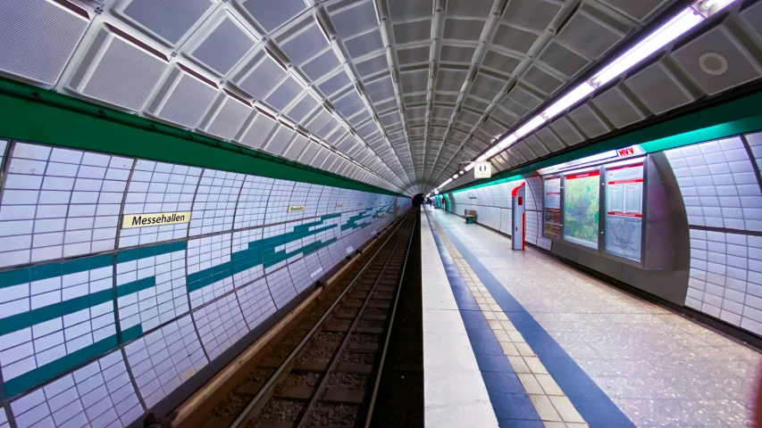 some subway tracks with different colored and white tiles