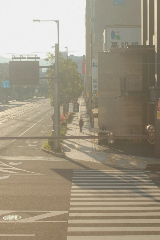 an empty city street with a stop sign at the corner