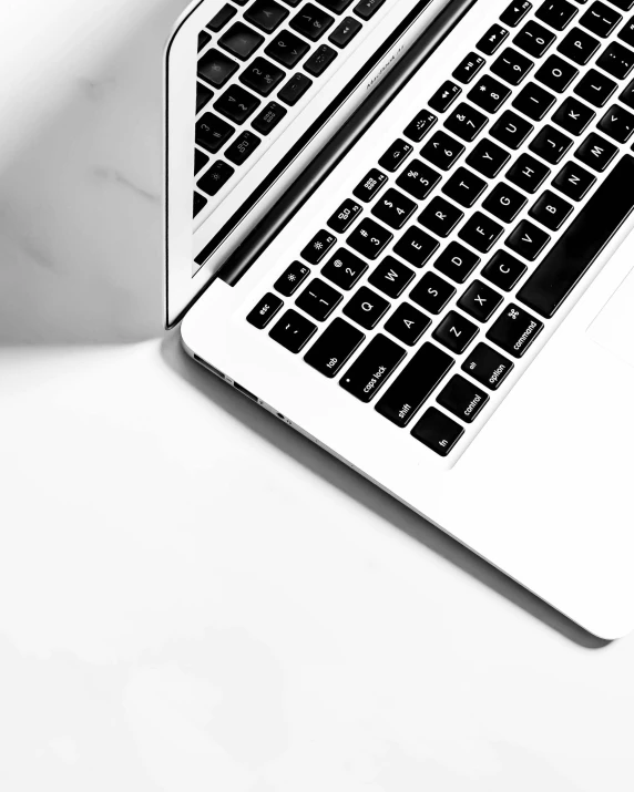 black and white image of two laptops side by side