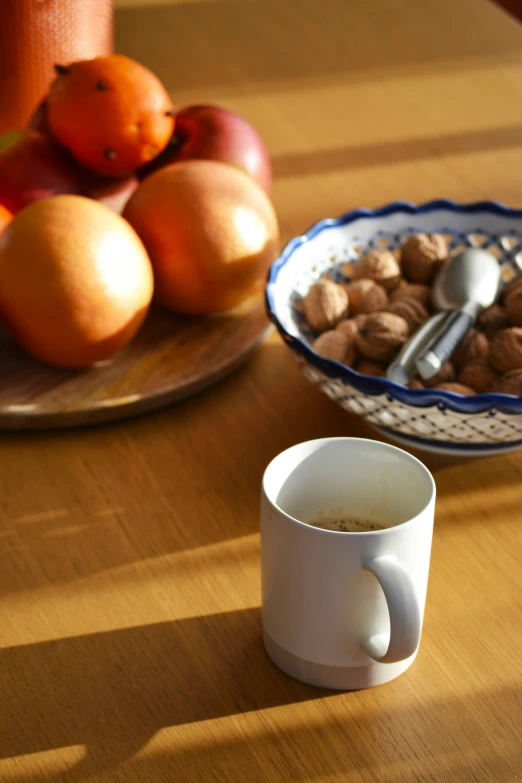 a close up of a mug on a table next to food