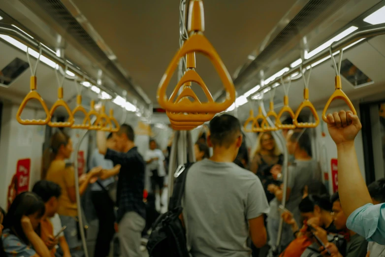 people moving on a subway with their arms up