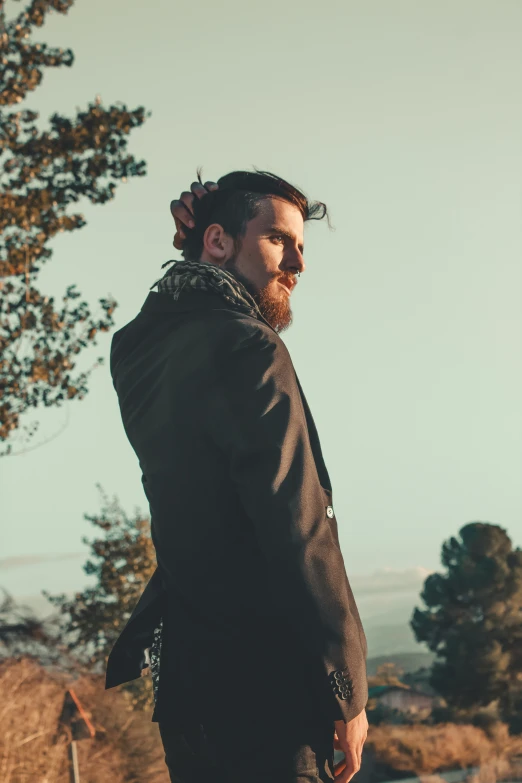 man in suit standing on sidewalk with view