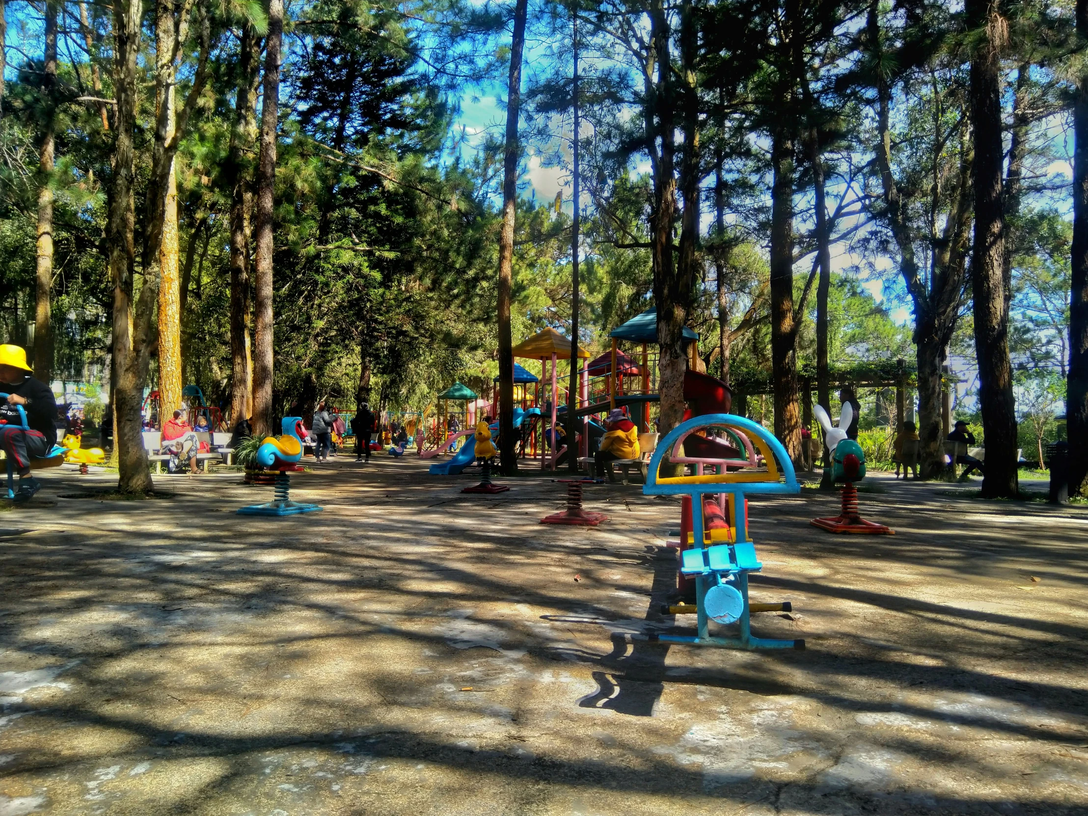 playground equipment in the middle of a sandy play area