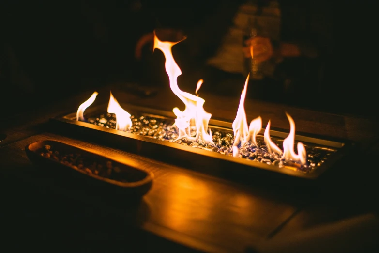 flames glow in the dark over a table