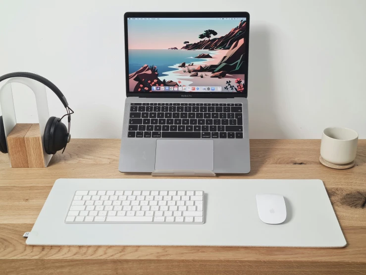 laptop with headphones and headphone on a wooden desk