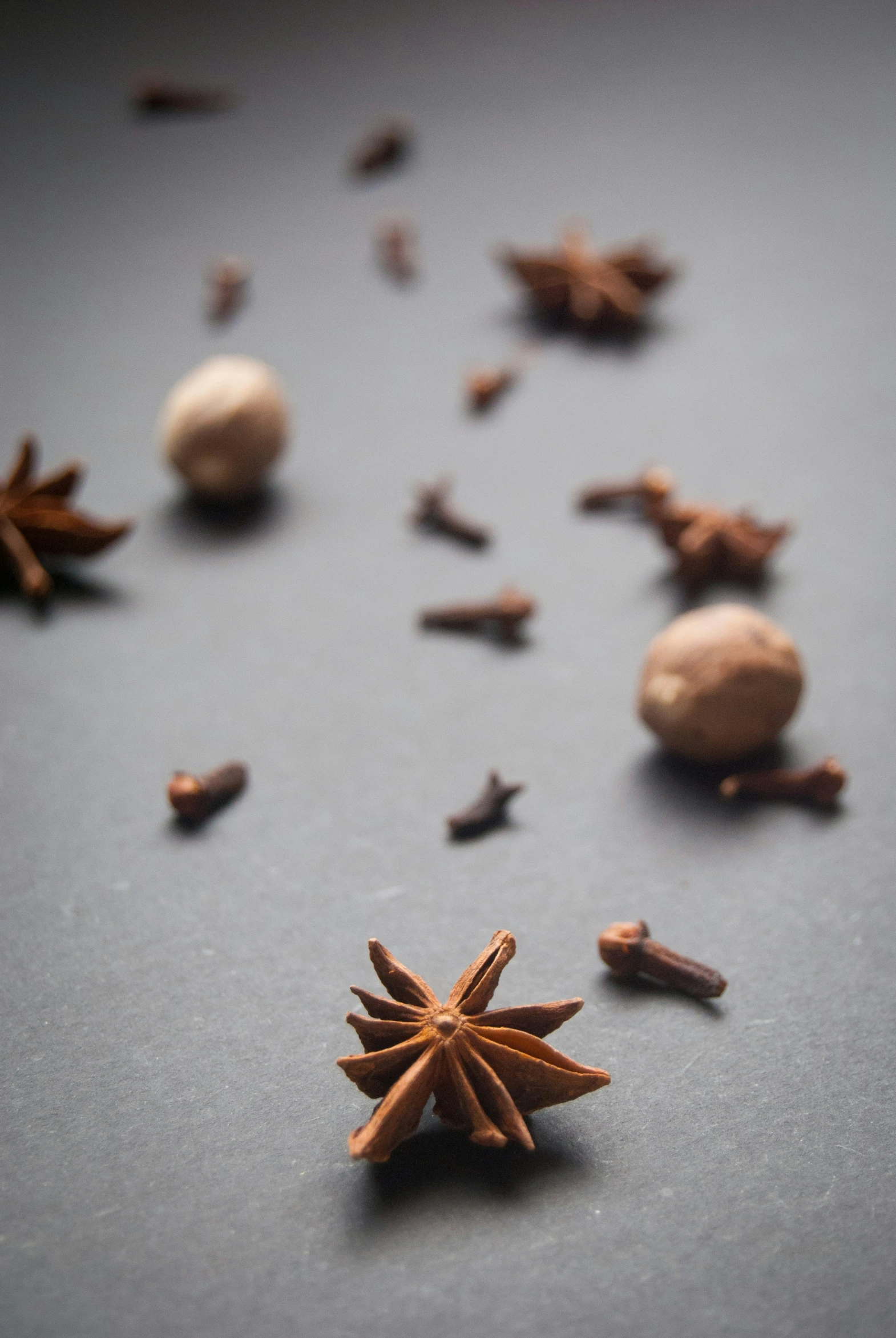 an assortment of spices with small objects scattered around