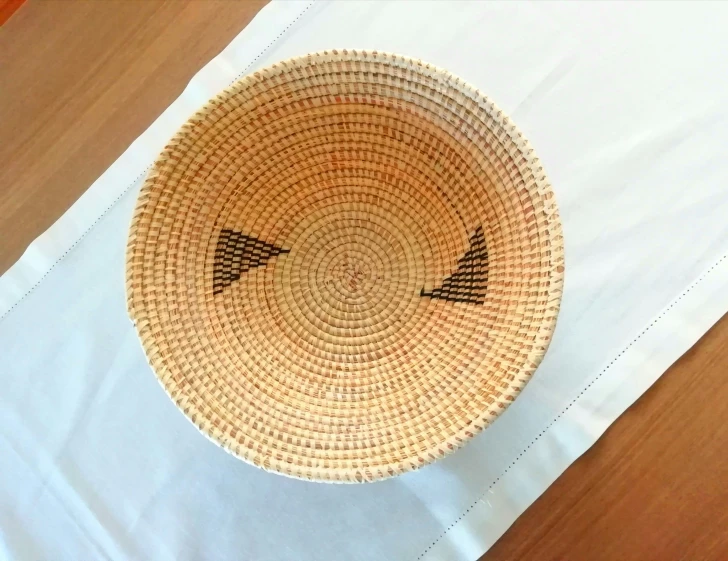 a small, woven basket sitting on a wooden table