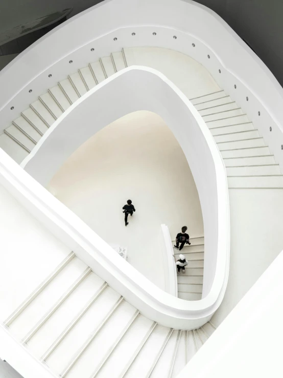 three people on the stairs and in a circular building