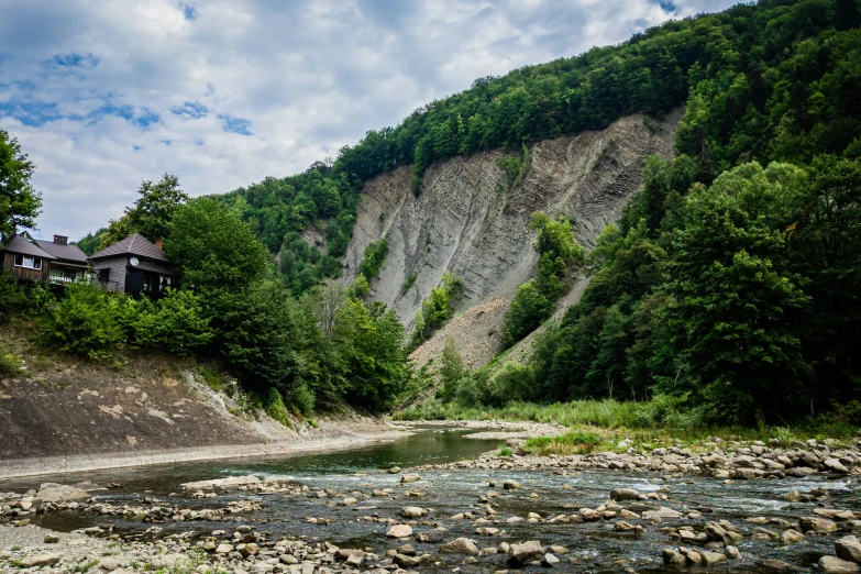 a scenic po of some mountains with a river running through them