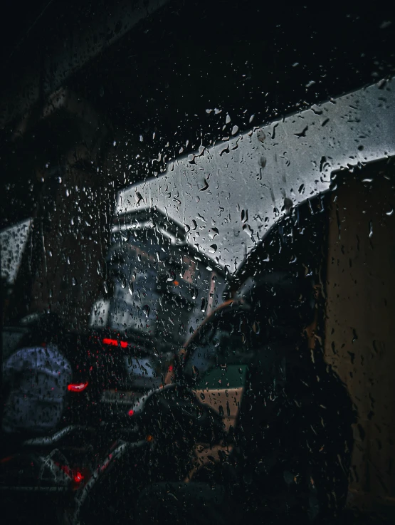 cars are driving down a road in the rain