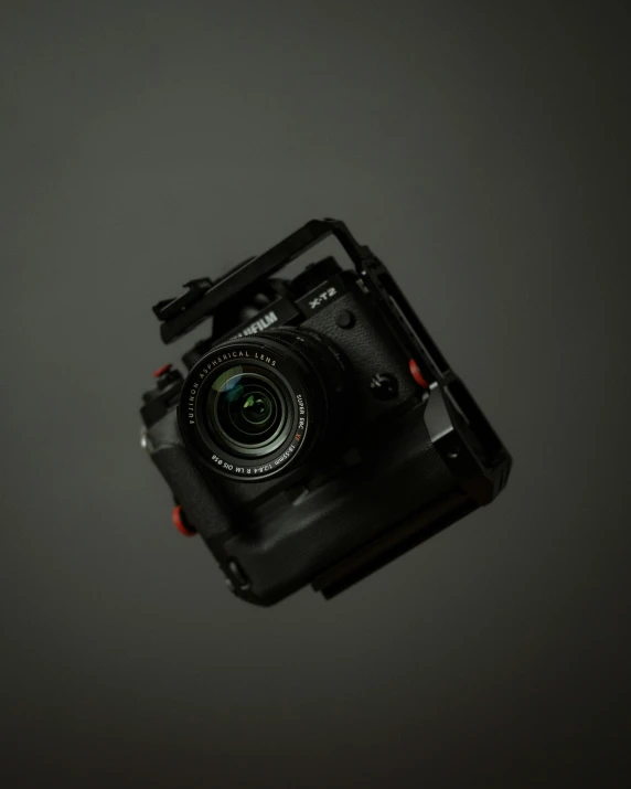 a small black camera sitting on top of a black table