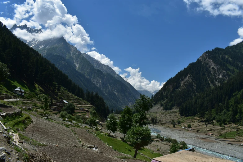 a green valley with some mountains in the background