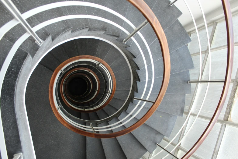 view down a very high spiral staircase in an office building