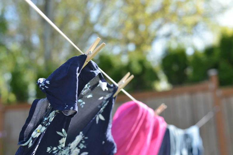 four clothes are hanging on a clothes line