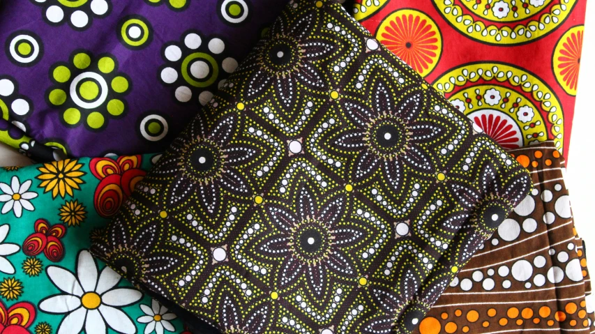 an assortment of different colored cloths with flower designs