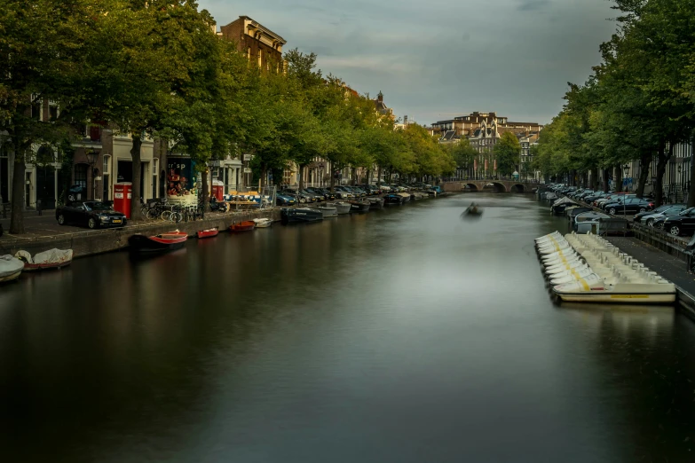 the boats are lined up along the river in the city