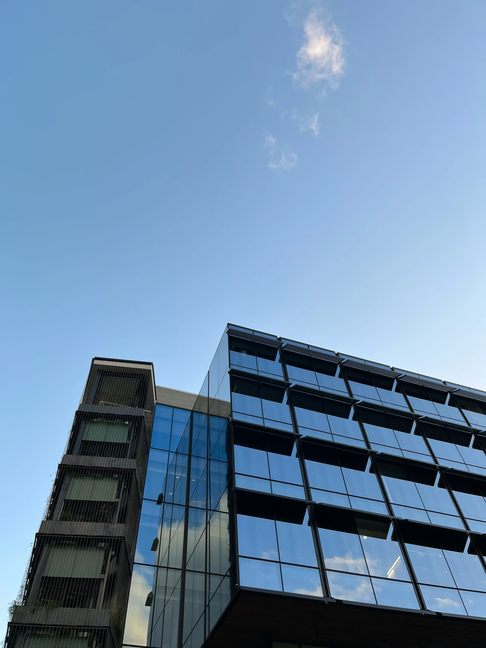 an airplane flying over a tall office building