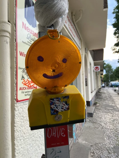 a yellow parking meter sitting on the side of a street