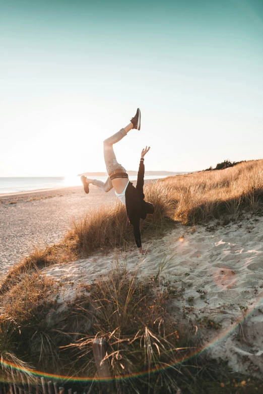 a person doing yoga on the beach near a body of water