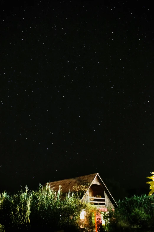 a small house with a night sky in the background