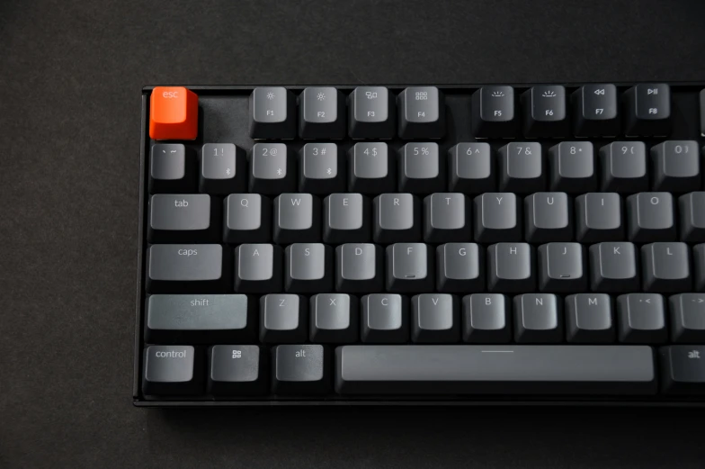 a black keyboard with two red ons on it