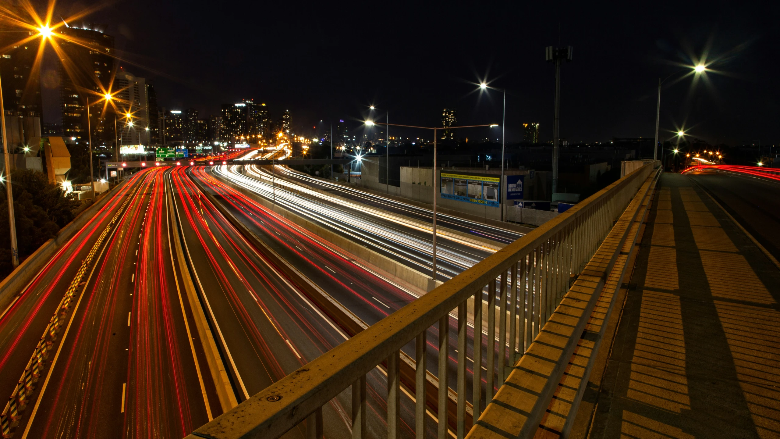 a city at night with a long exposure of light streaks