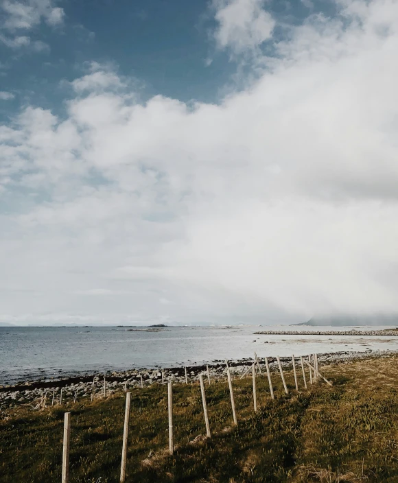 a sandy beach is on a cloudy day