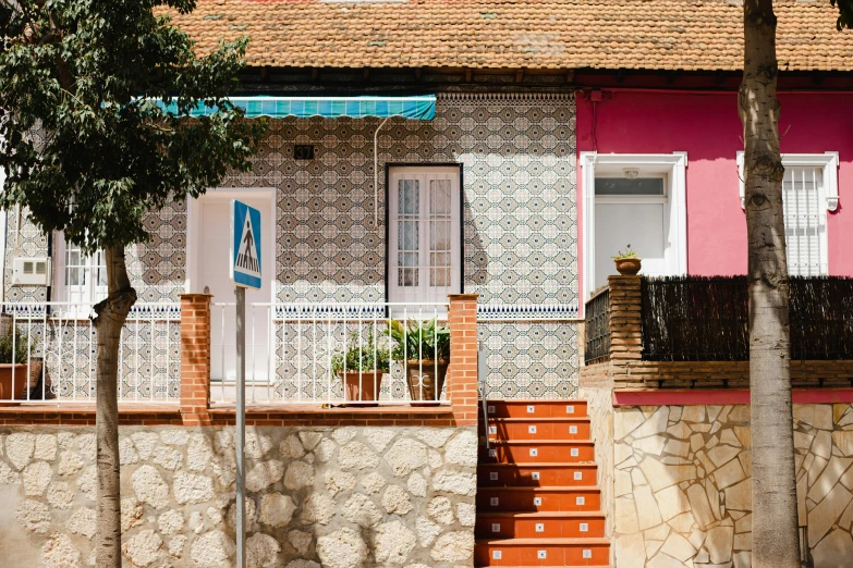 red steps lead up to a house with colorful windows