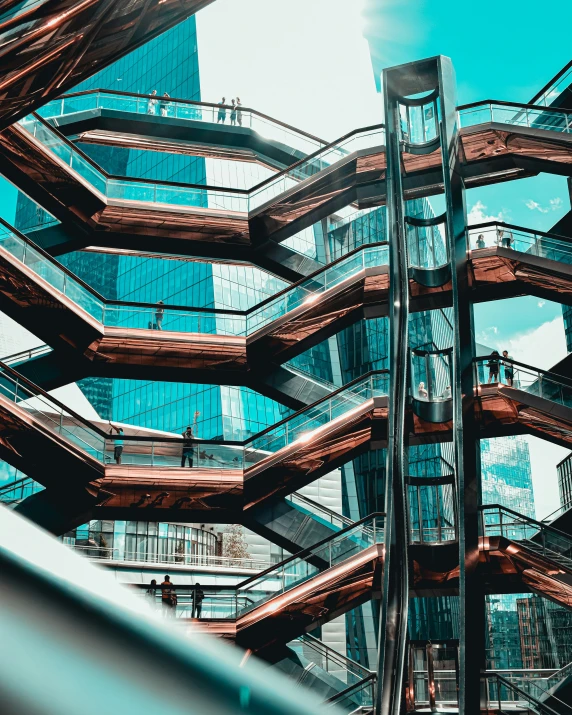 looking up at a metal spiral structure with blue buildings in the background