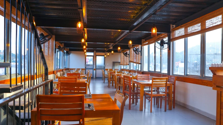 a restaurant with many wooden chairs and wooden tables