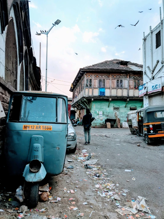 two cars parked in front of old buildings