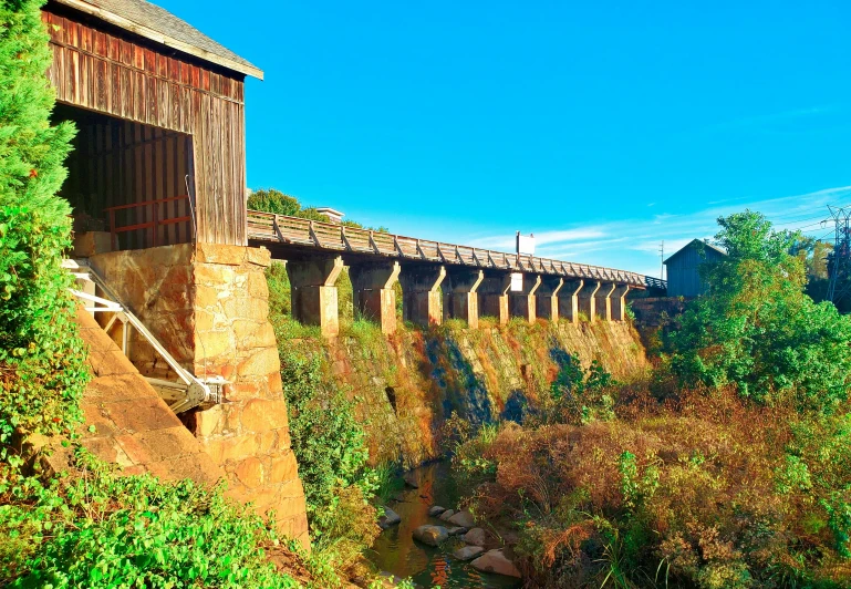 an old train engine and its caboose sitting near a bridge