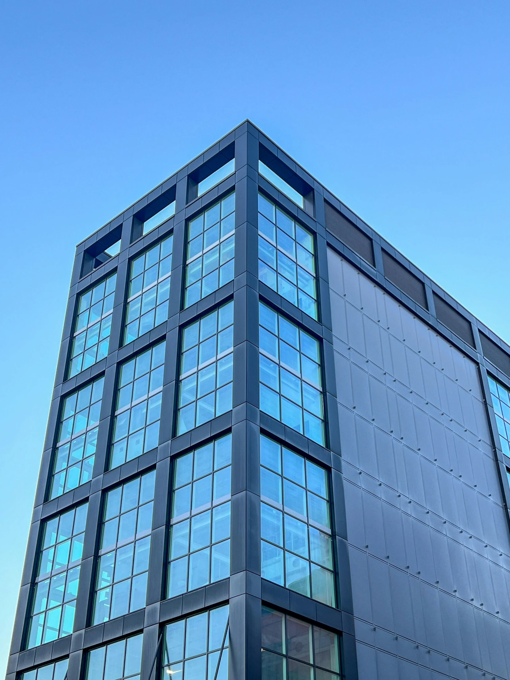 a black office building with many windows and signs on it