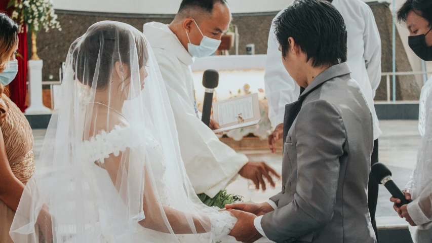 a bride and groom during a ceremony at a church