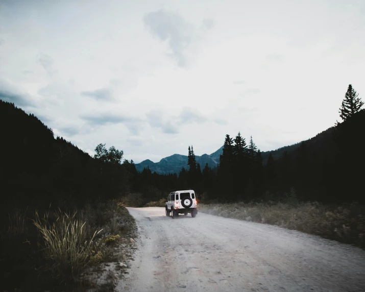 an old van sits on the road in the country side