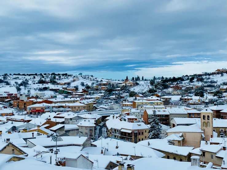 a town covered in snow with lots of buildings on top