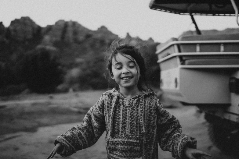 a young child standing in front of a boat