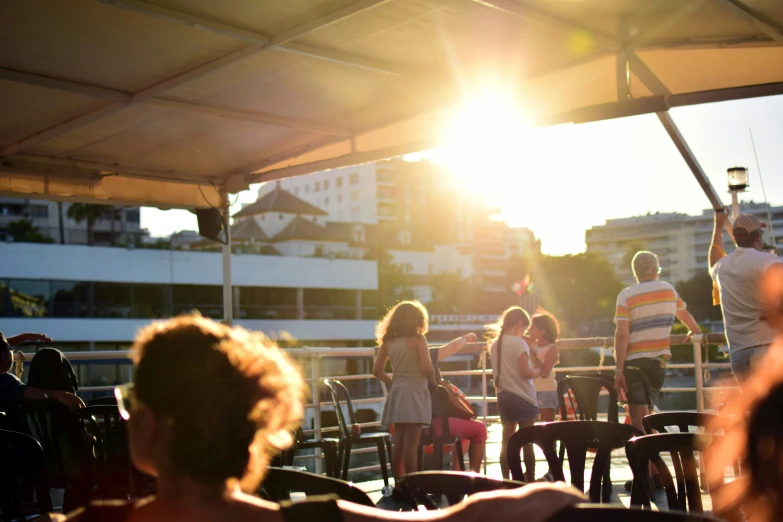 some people stand under a canopy near some chairs