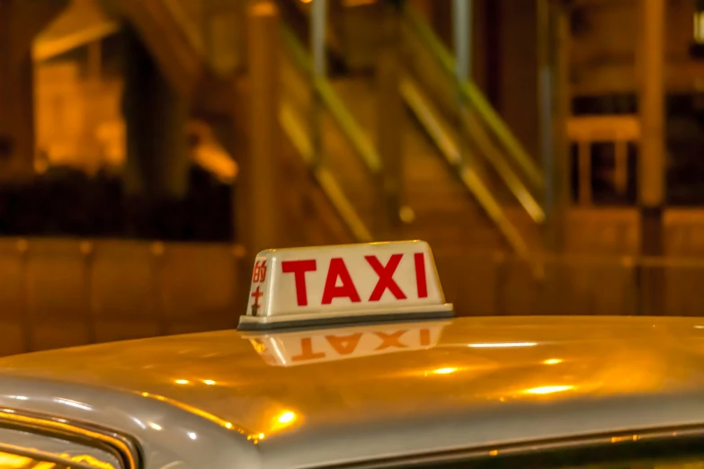 taxi cab number plate that is yellow and red