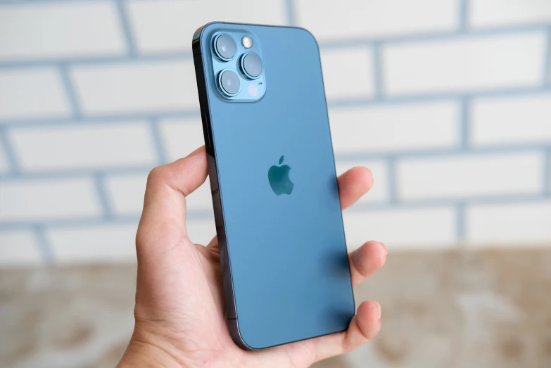 a hand holding an iphone x case, next to the back of its box