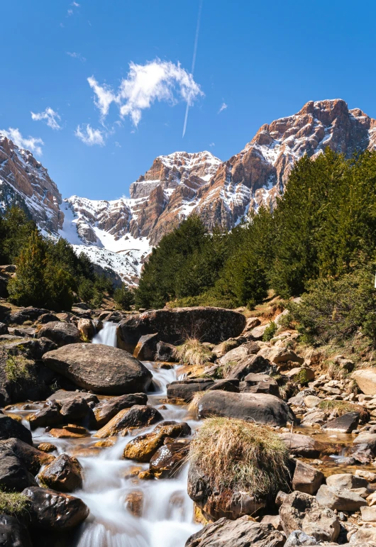 water in the river surrounded by rocks in a mountain range