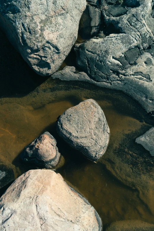 some very large rocks and some brown water