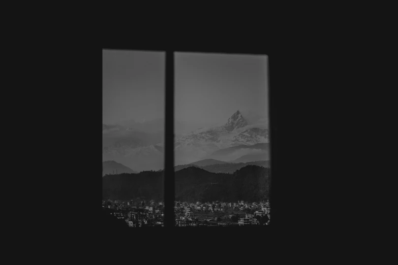a window showing a mountain in the distance