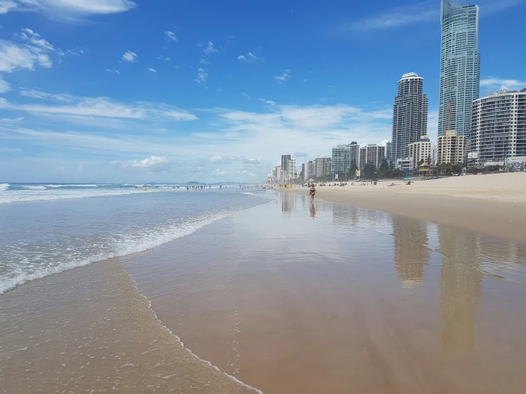 people are on the beach looking at the water