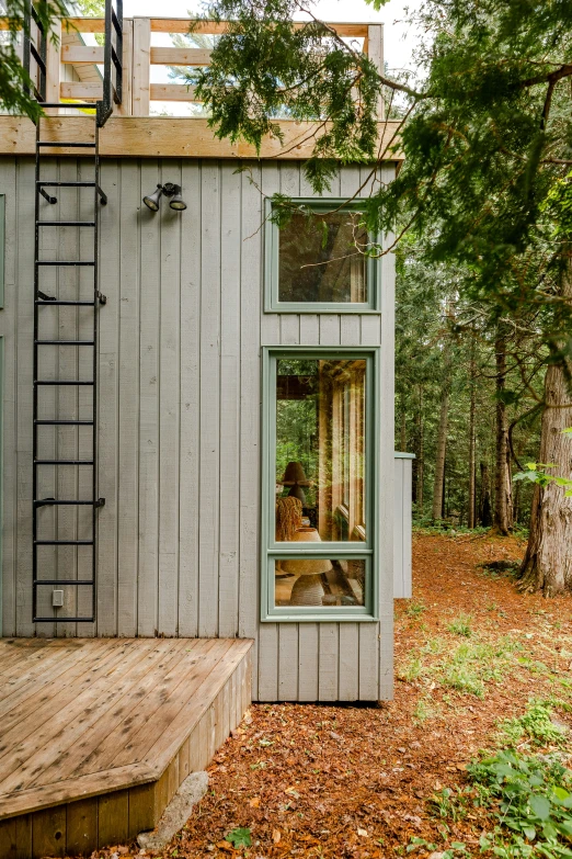 a small wooden shed with a window in the side of it