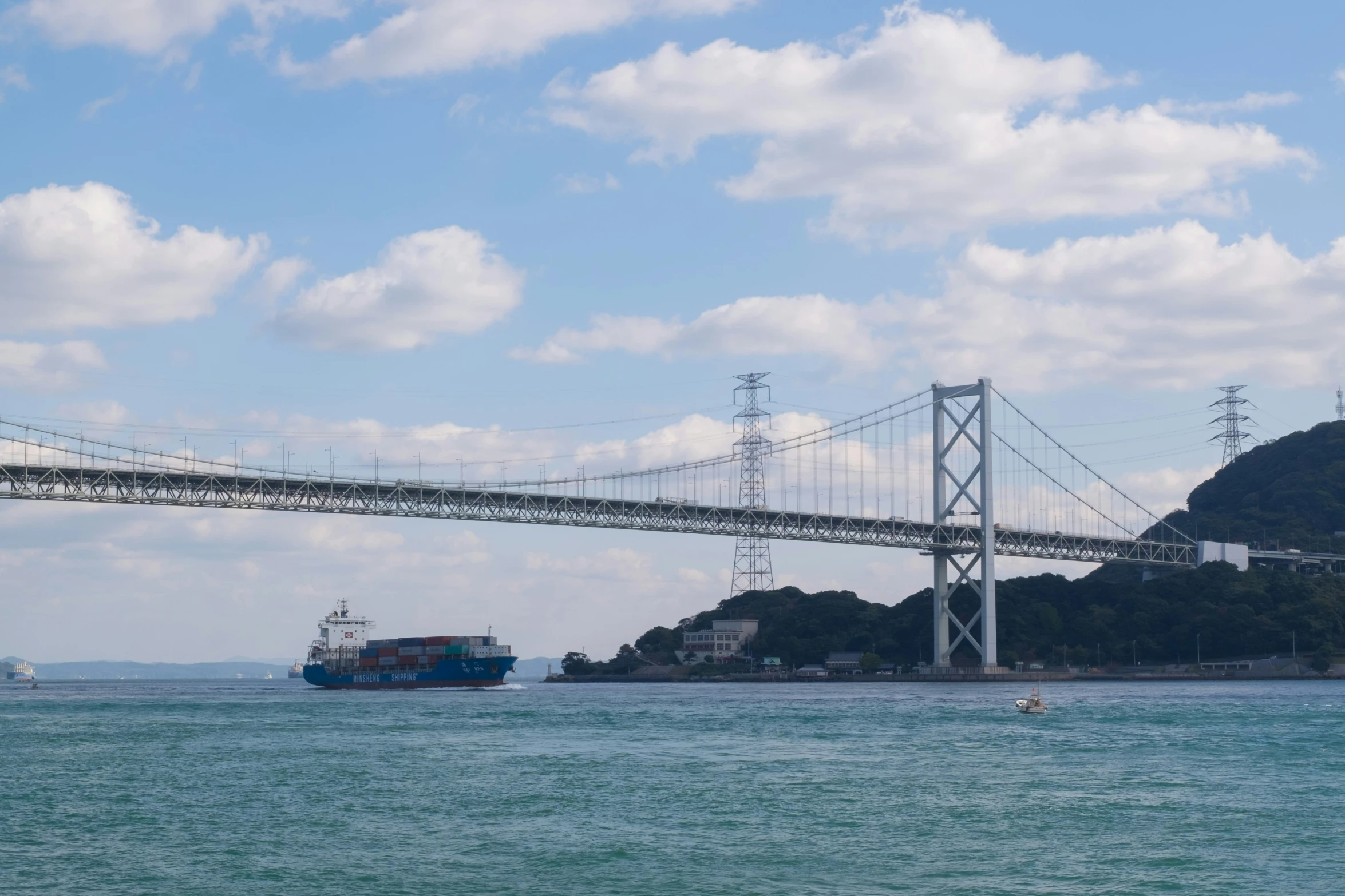 a boat is out on the water near a bridge