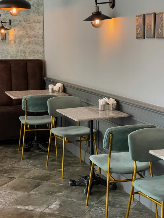 the interior of a restaurant with two long wooden tables and chairs