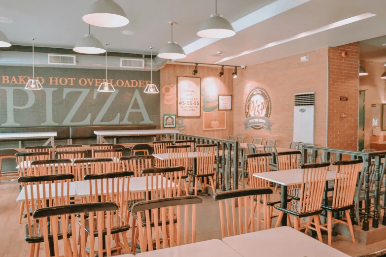 a pizza restaurant filled with empty wooden chairs